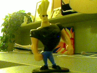 a toy character standing on top of a desk