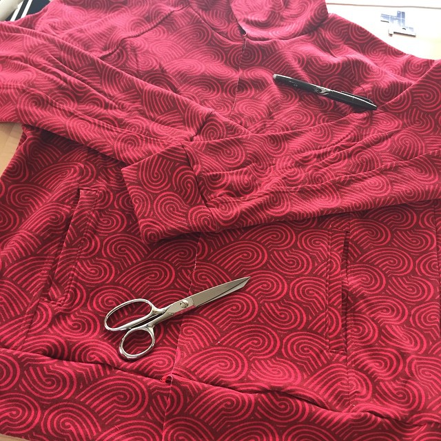 scissors are laid out on the cloth and a pair of scissors are also on top