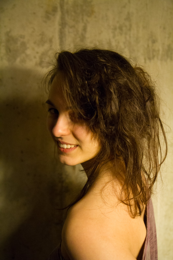 a smiling woman with brown hair wearing a tank top