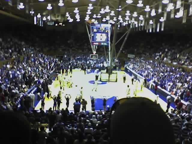 a large basketball arena with an audience and lots of lights
