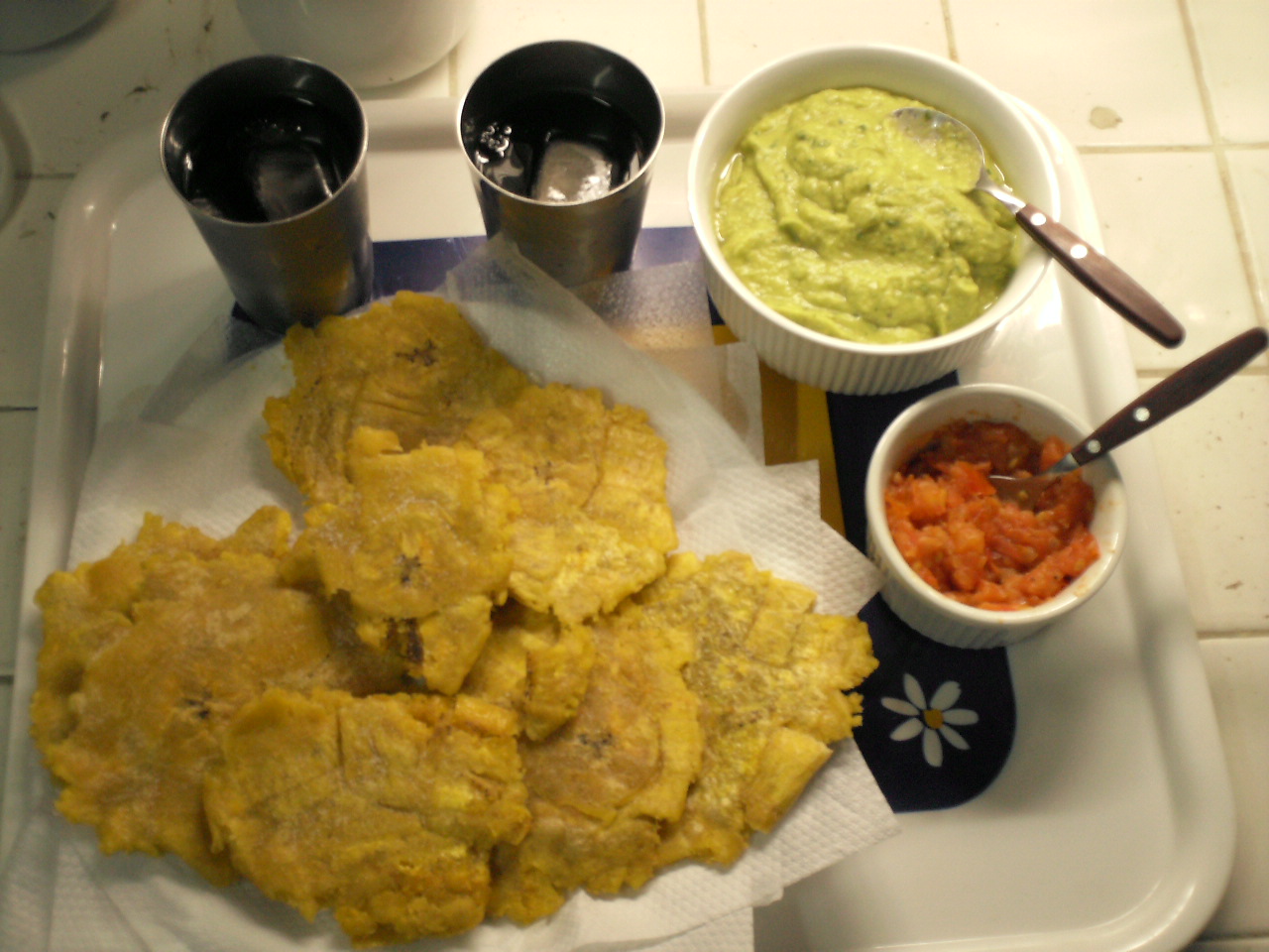 cornbread fritters, guacamole sauce and a drink on a tray