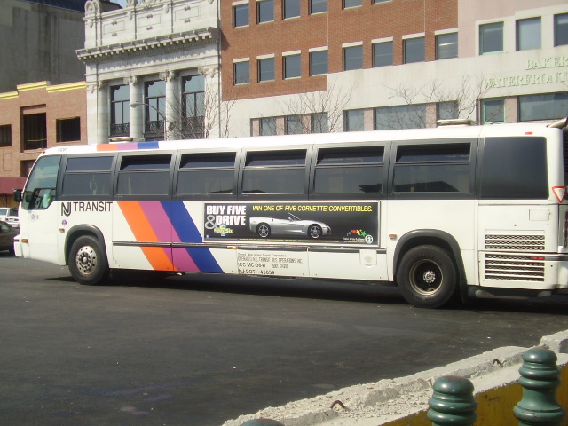 a bus with various graphic on it traveling down the street