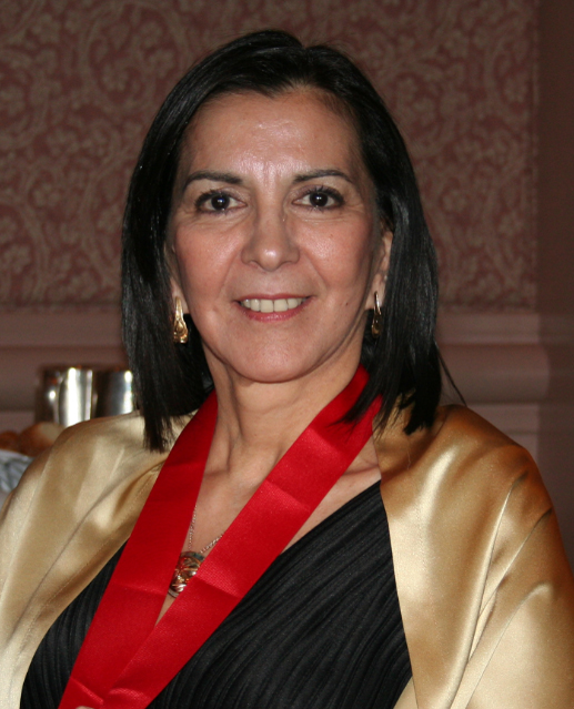 a woman wearing a shiny gold jacket with red tie