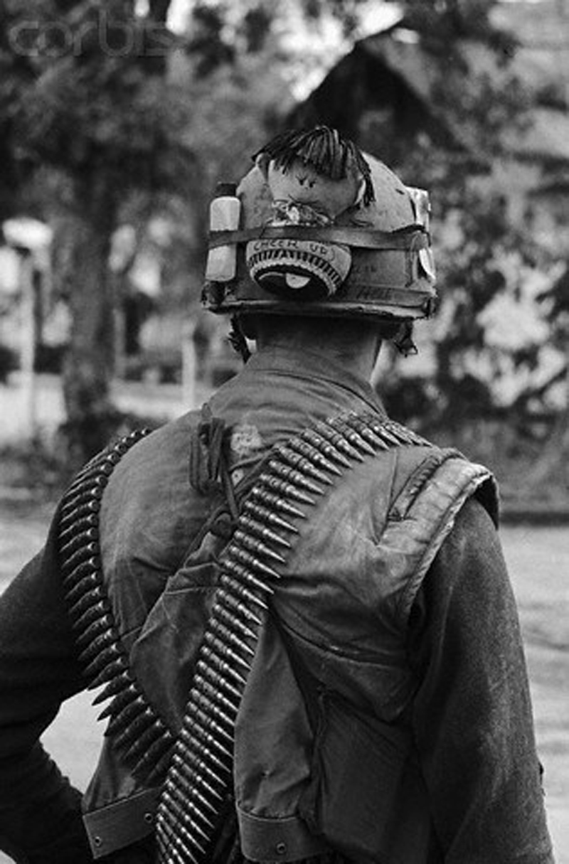 a black and white po shows a person wearing a helmet holding an m & p rifle
