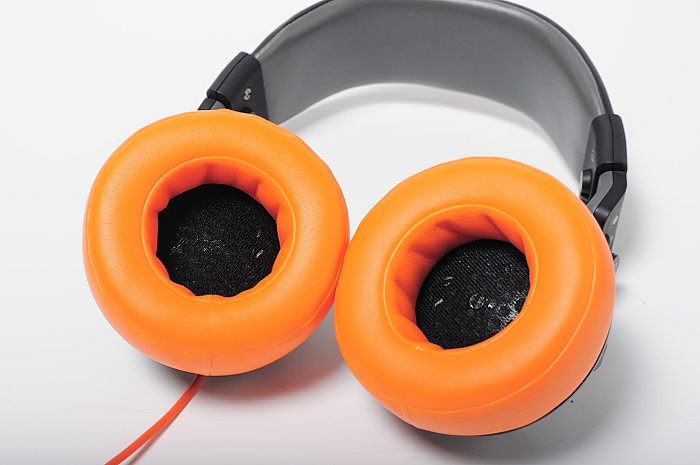 a couple of orange headphones sitting on top of each other