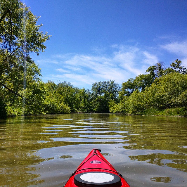 a person in a red kayak looking back