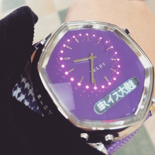 a purple watch with an arabic text displayed on the face