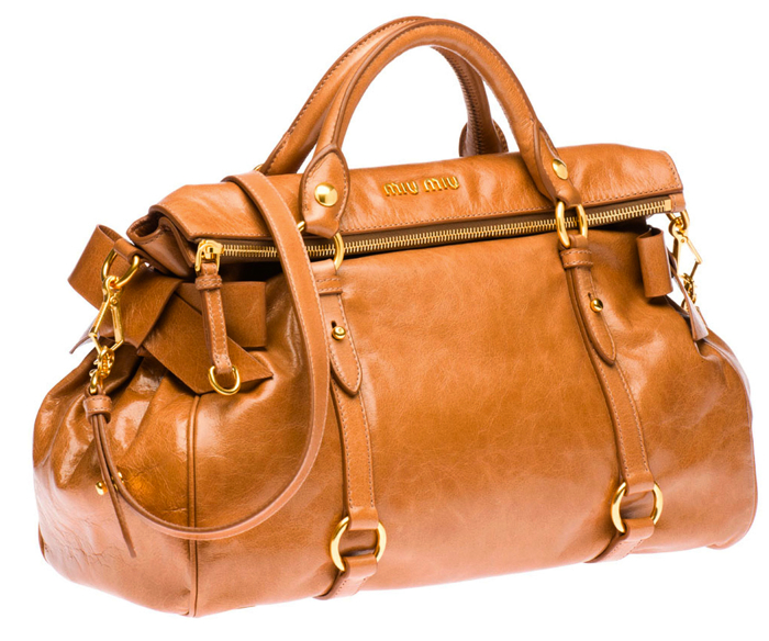a brown leather duffel bag with an open zipper