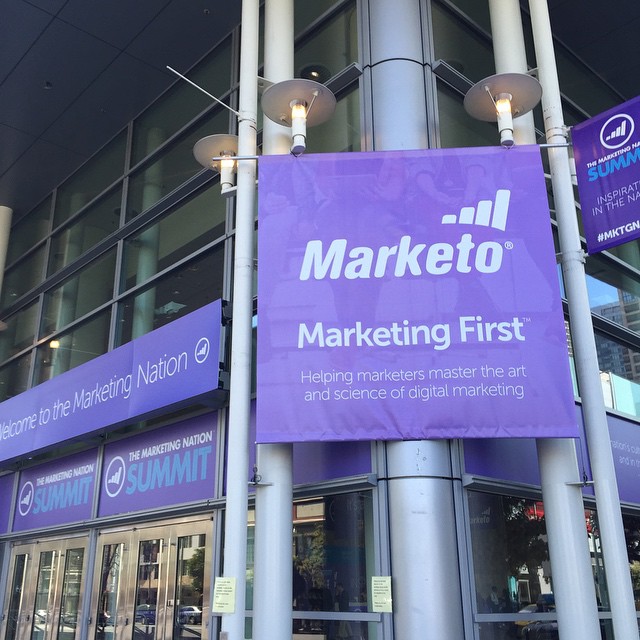 a purple advertising sign outside a shopping center