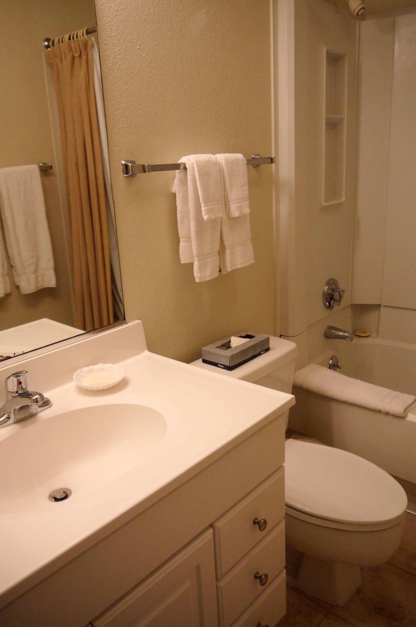 a bathroom with a toilet, shower, sink and bath tub
