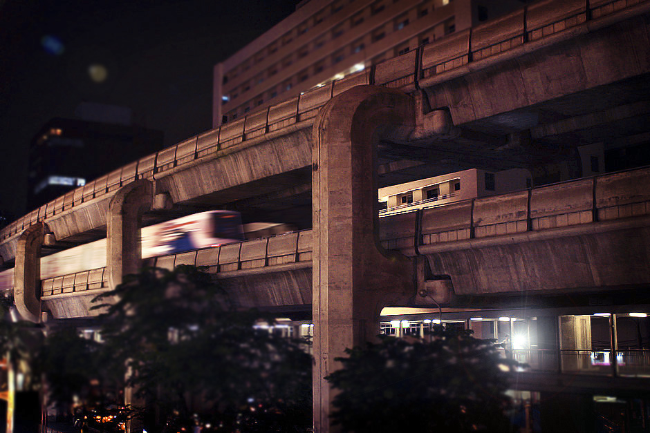 a train going down the tracks near some tall buildings