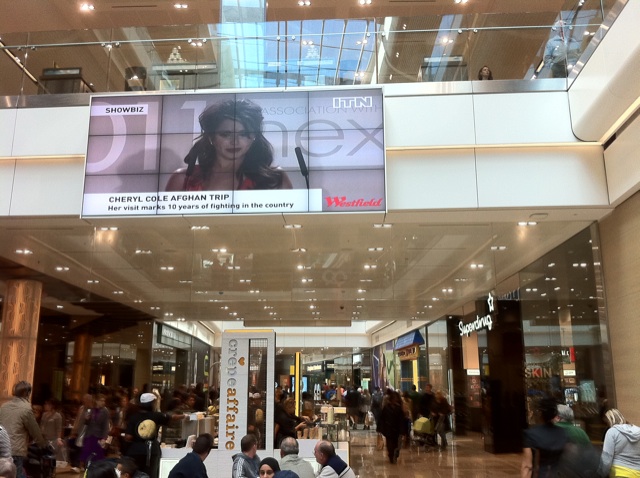 an overhead television screen in a lobby