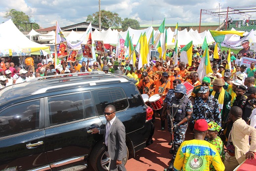 a group of people walking in front of an suv