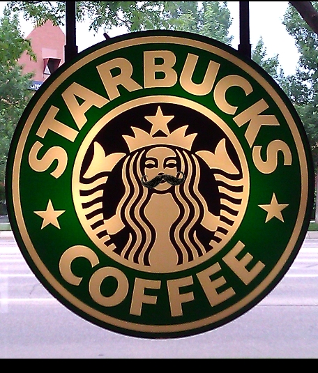 the starbucks sign is painted green and gold