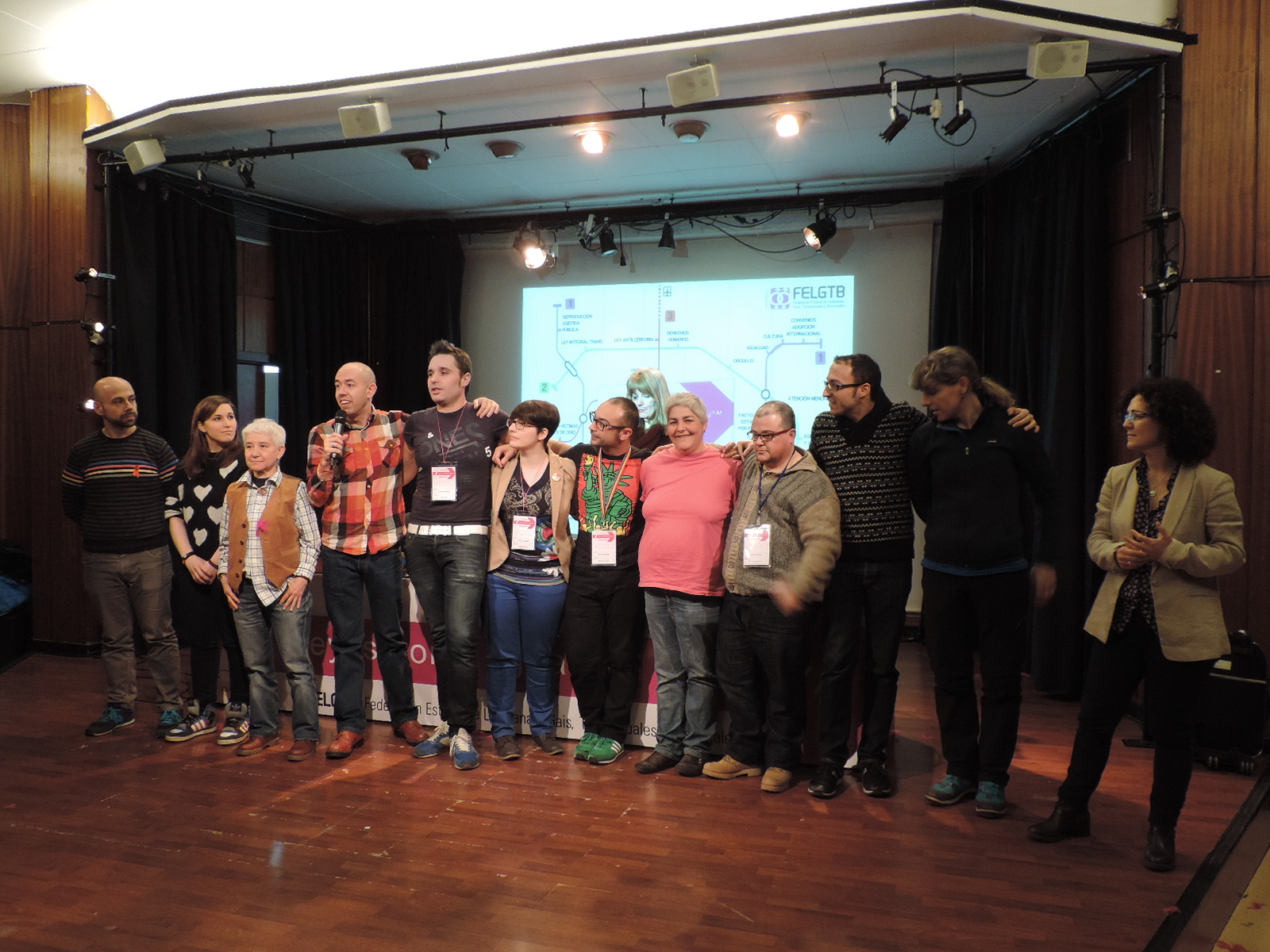 a group of people standing in front of a projection screen