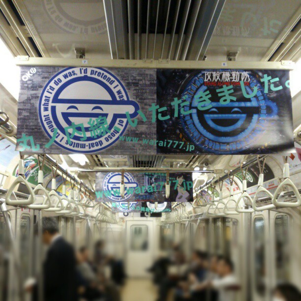 a subway with several signs attached to the ceiling