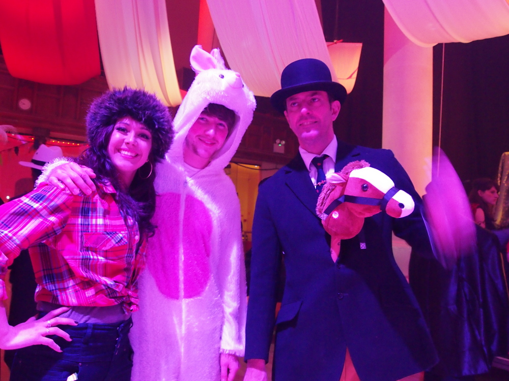 two ladies are dressed up as animals, and one man is dressed in a rabbit costume