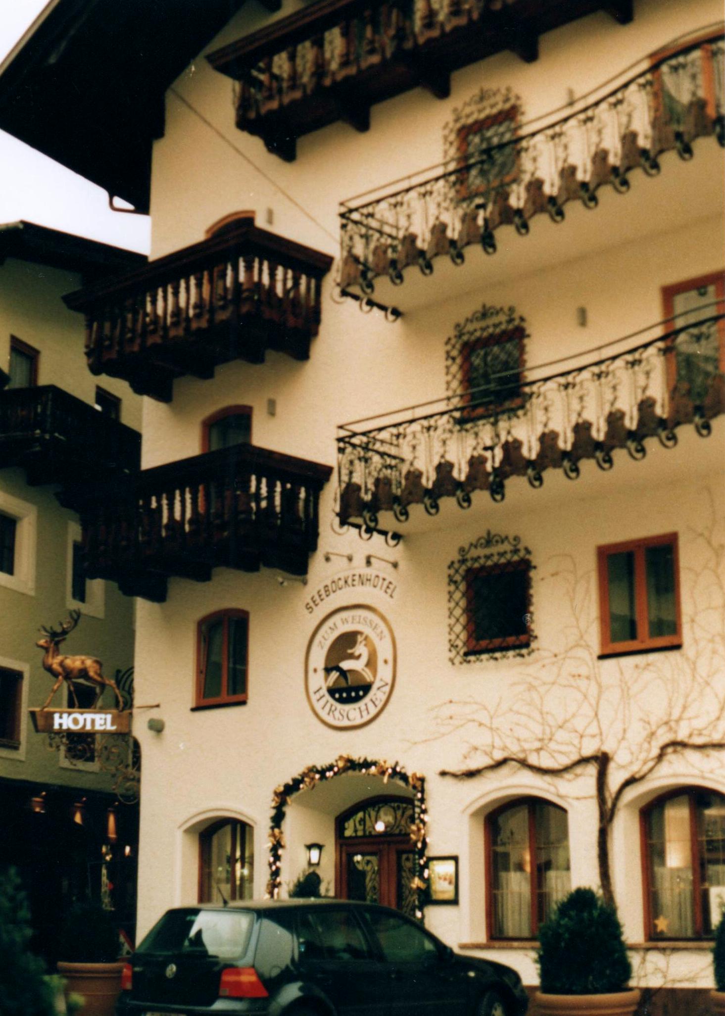 a parked car and a building with various things on the side