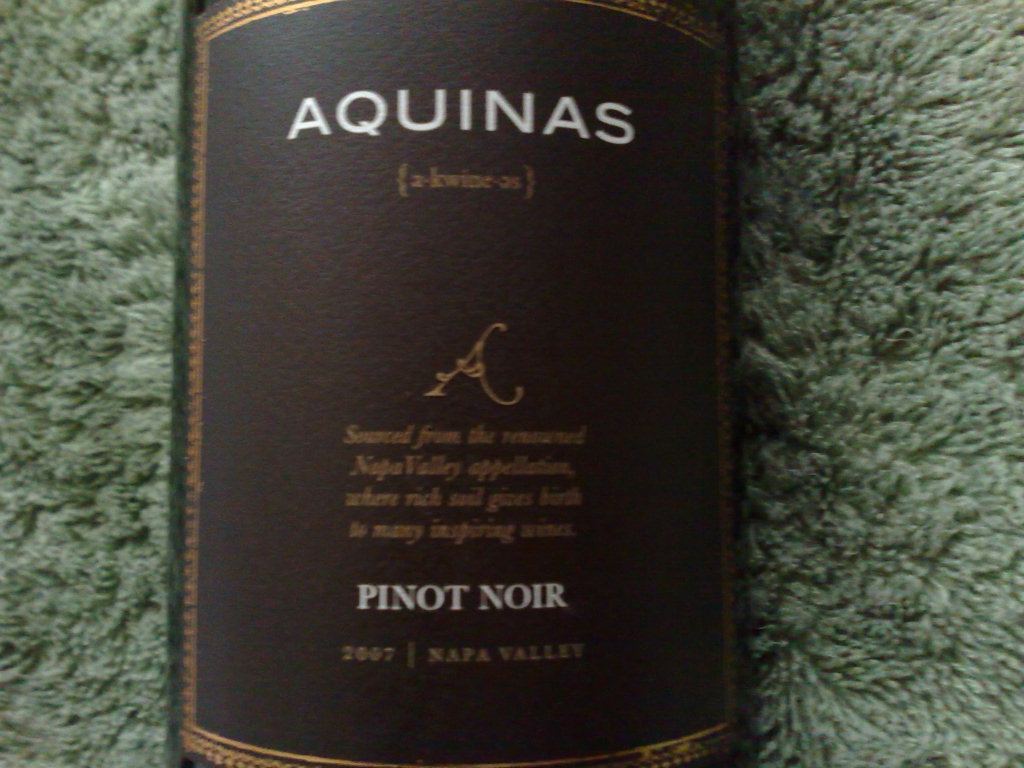 a bottle of wine that has been placed on a rug