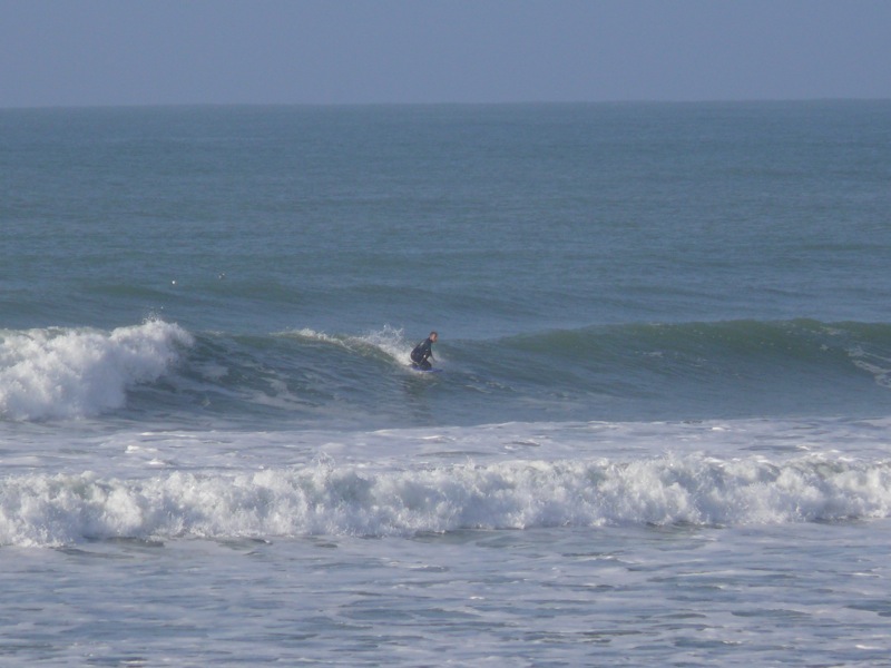 a man riding on top of a wave in the ocean