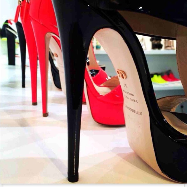 high heels sit in rows against a display