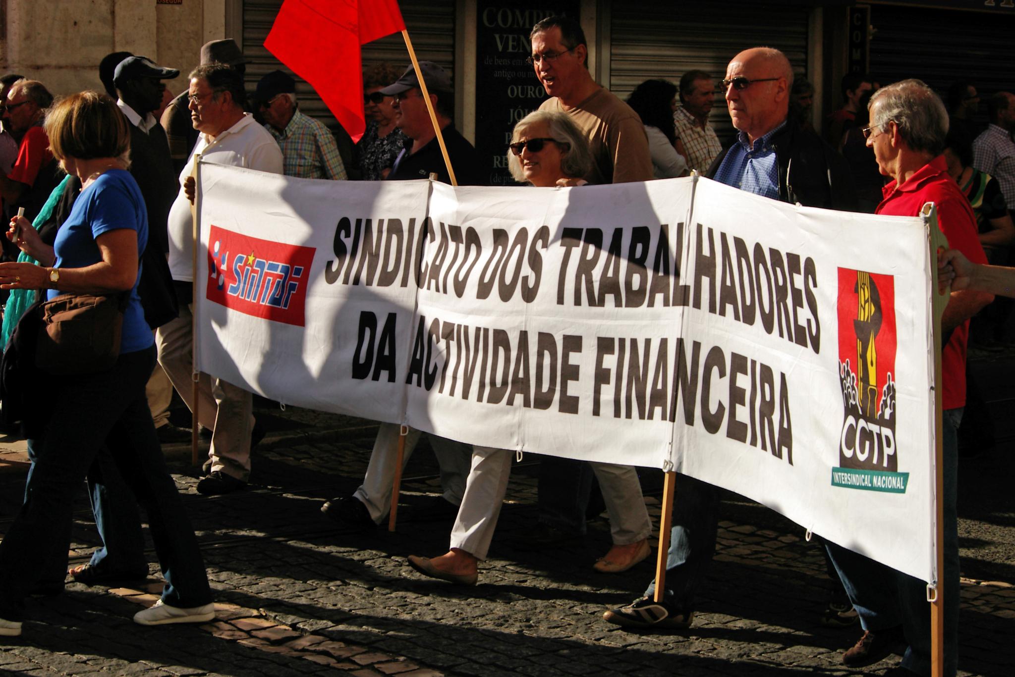 group of people holding a banner in a street