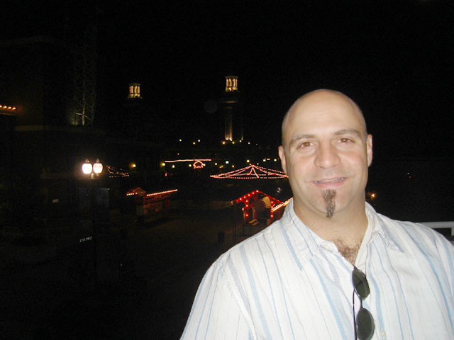 a man standing in a street at night