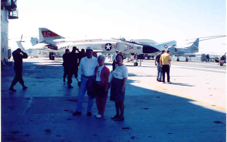 people are walking around a plane on the runway