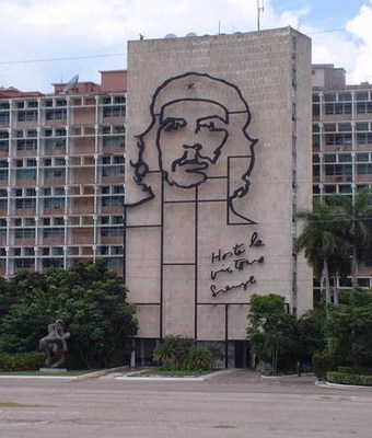 an apartment building in the midst of the day with a mural of a man in the middle of the building
