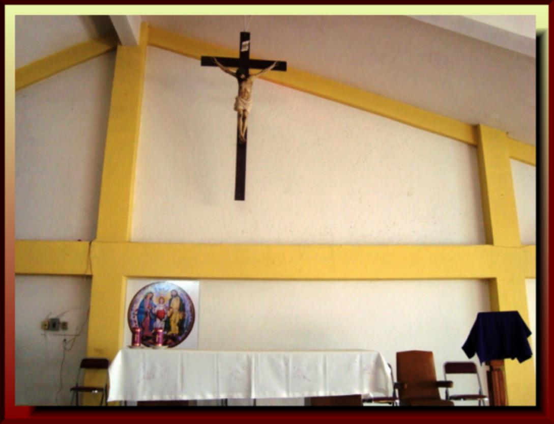 the cross on the wall next to a cloth dd table cloth