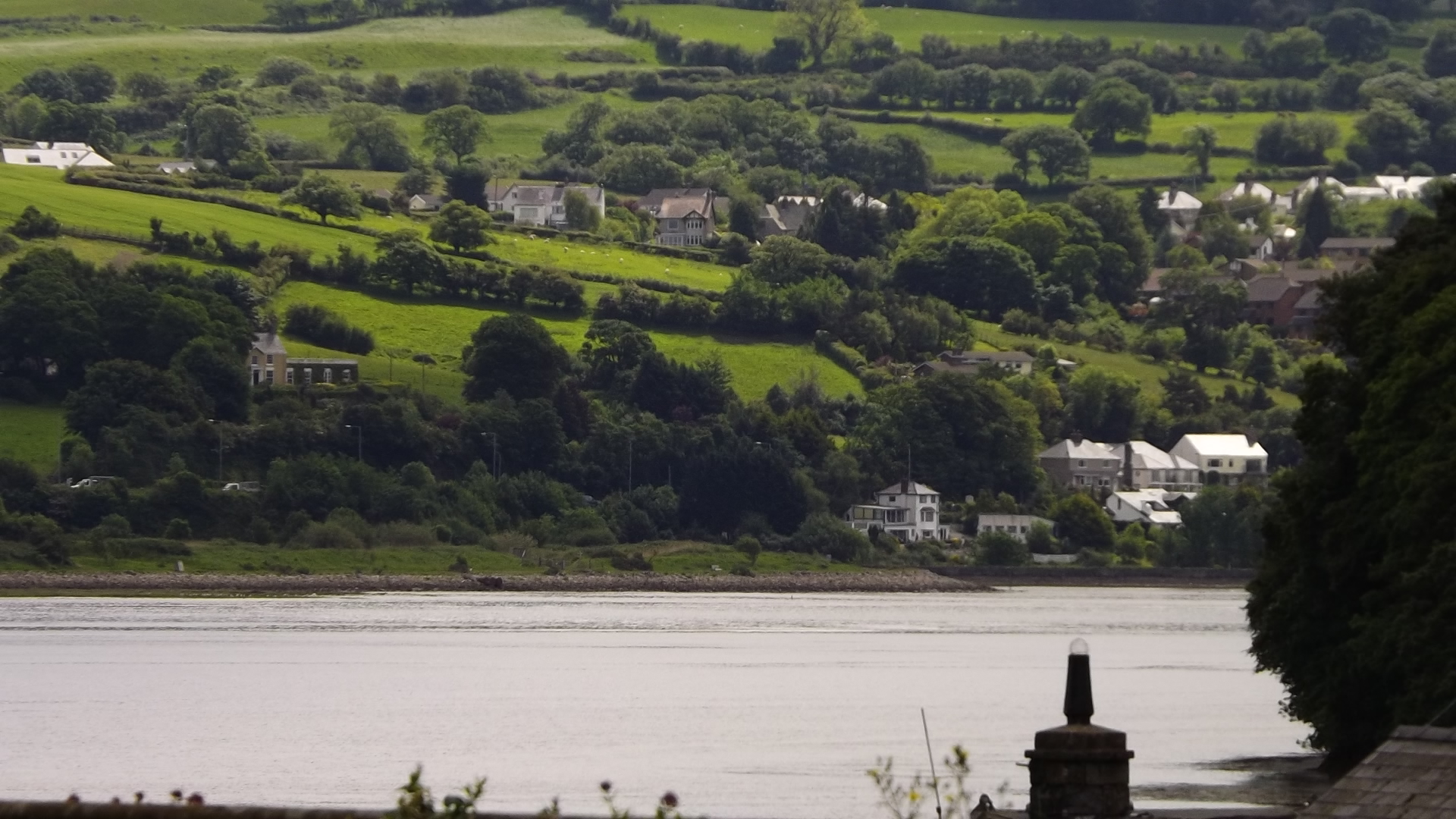 a view of a city and a lake near hills