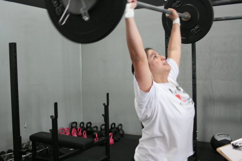 a woman is performing a powerlift exercise