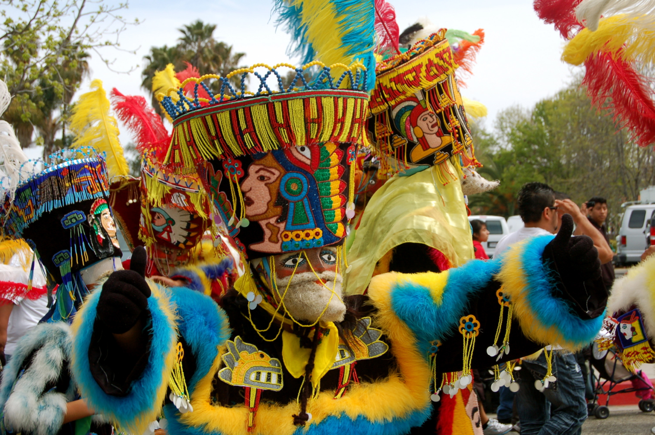 colorful costumes that include a man with a beard and large headdress