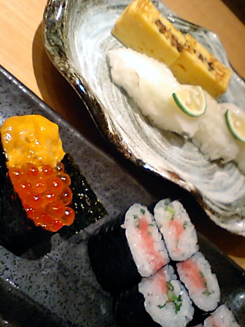 three different types of sushi on display in a dish
