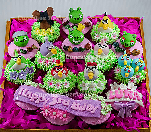 a box with cake decorations decorated like angry birds