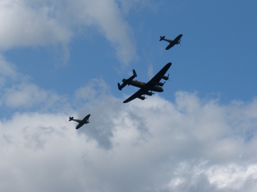 three airplanes fly in formation high in the sky