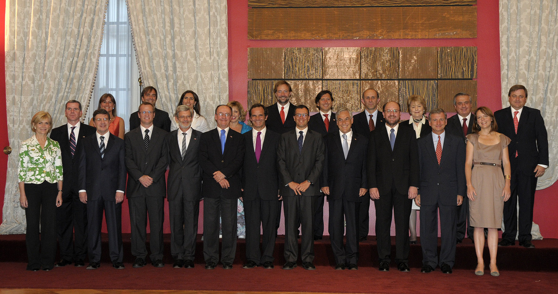 a group of people in suits and ties posing for a po