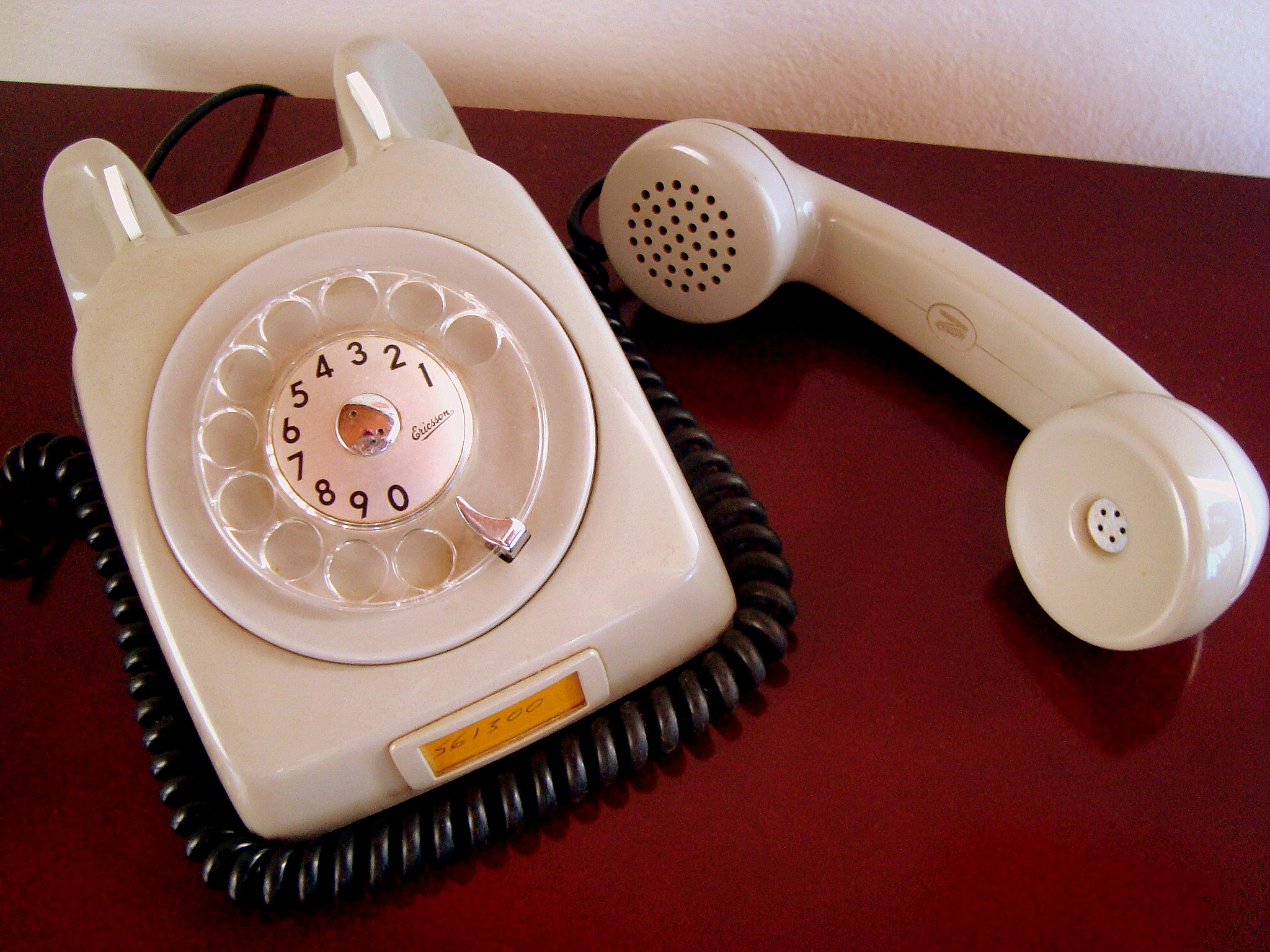 an antique telephone sits on a desk top