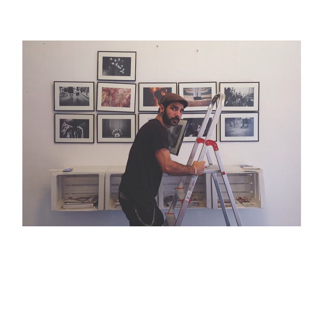 a man with a beard is painting pictures on the wall