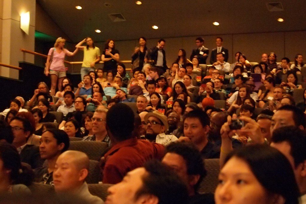 audience at the event taking pos on their phones