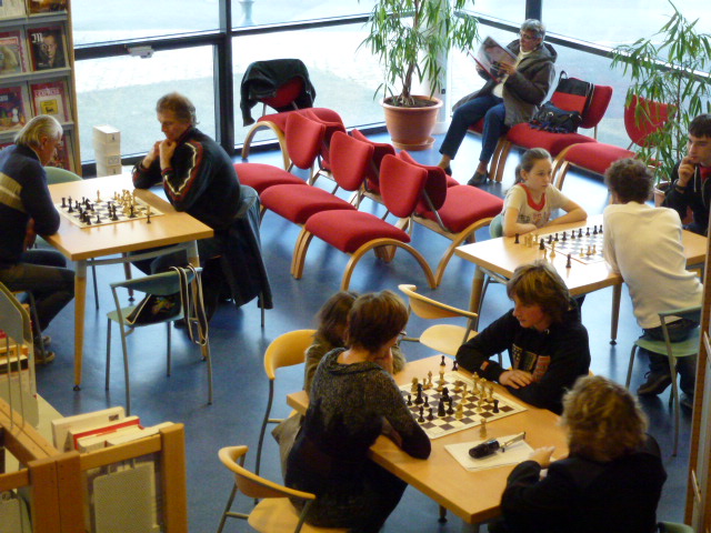 a large group of people playing chess together