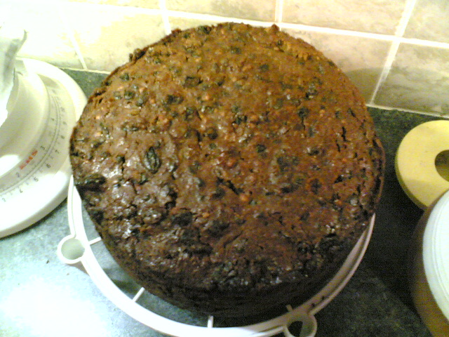 a cake is sitting on a white cake plate