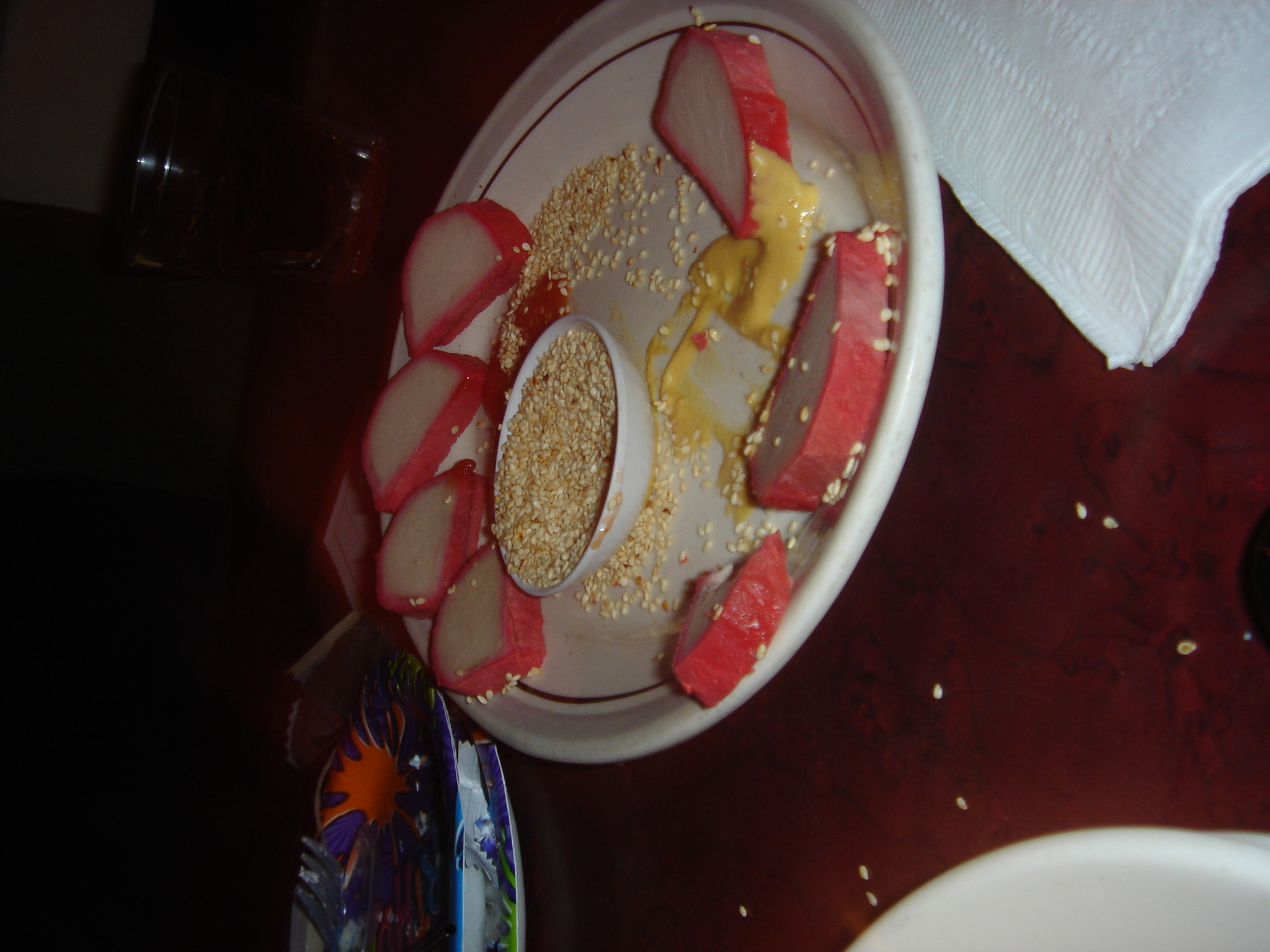 a plate with red and yellow fruits is on the table