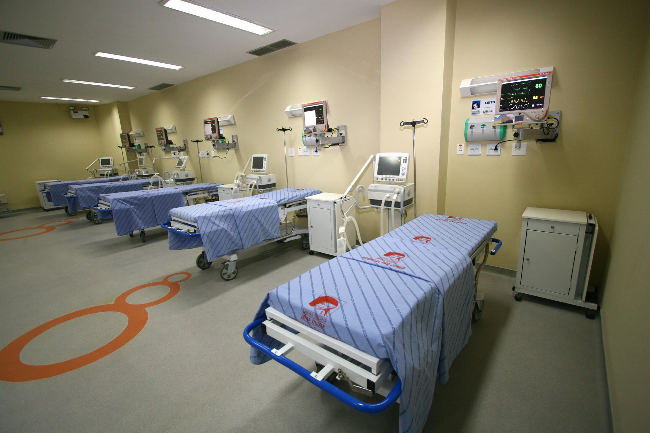 a medical room is shown with carts and monitors