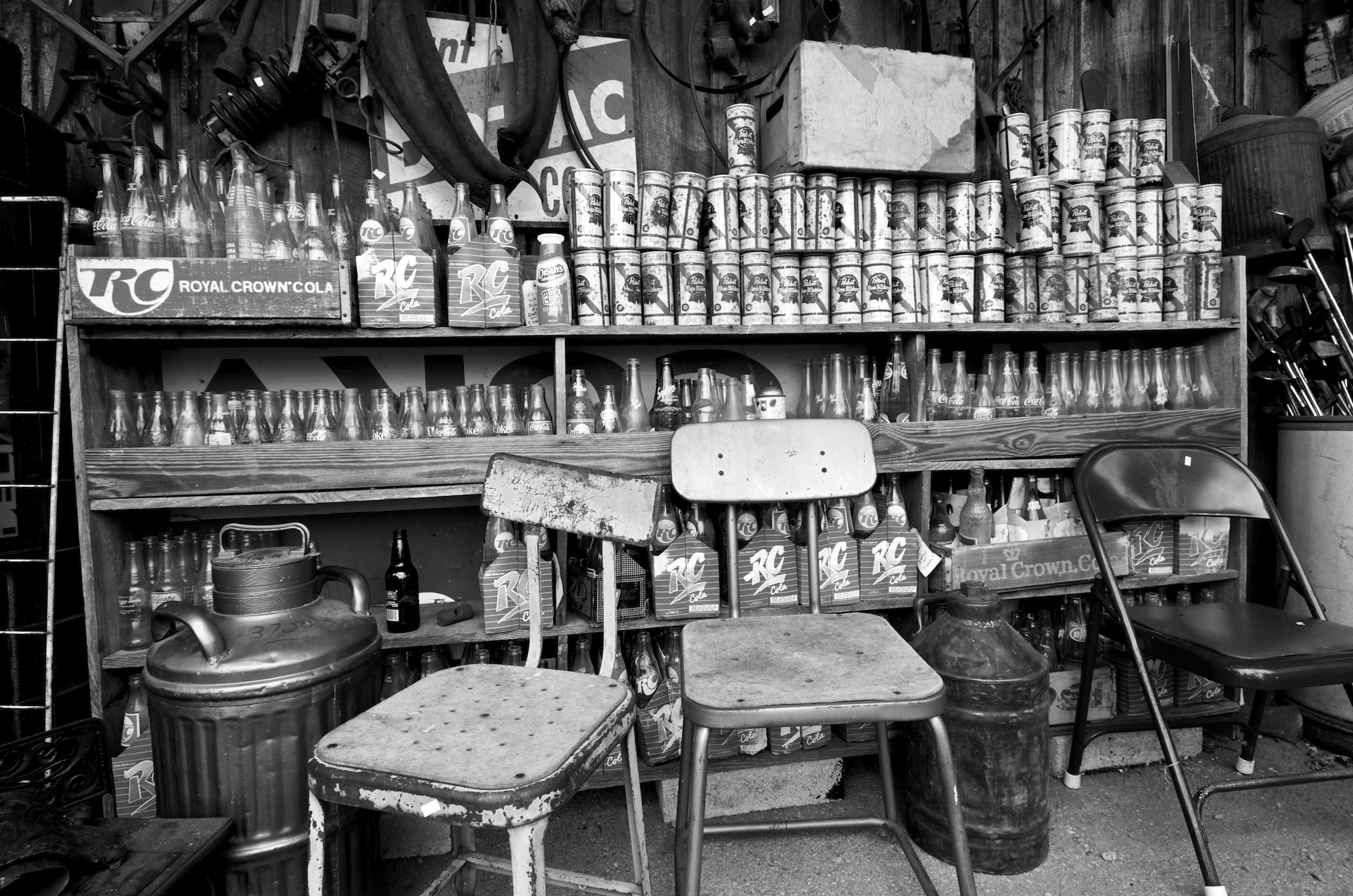 old furniture and soda cans on display in store