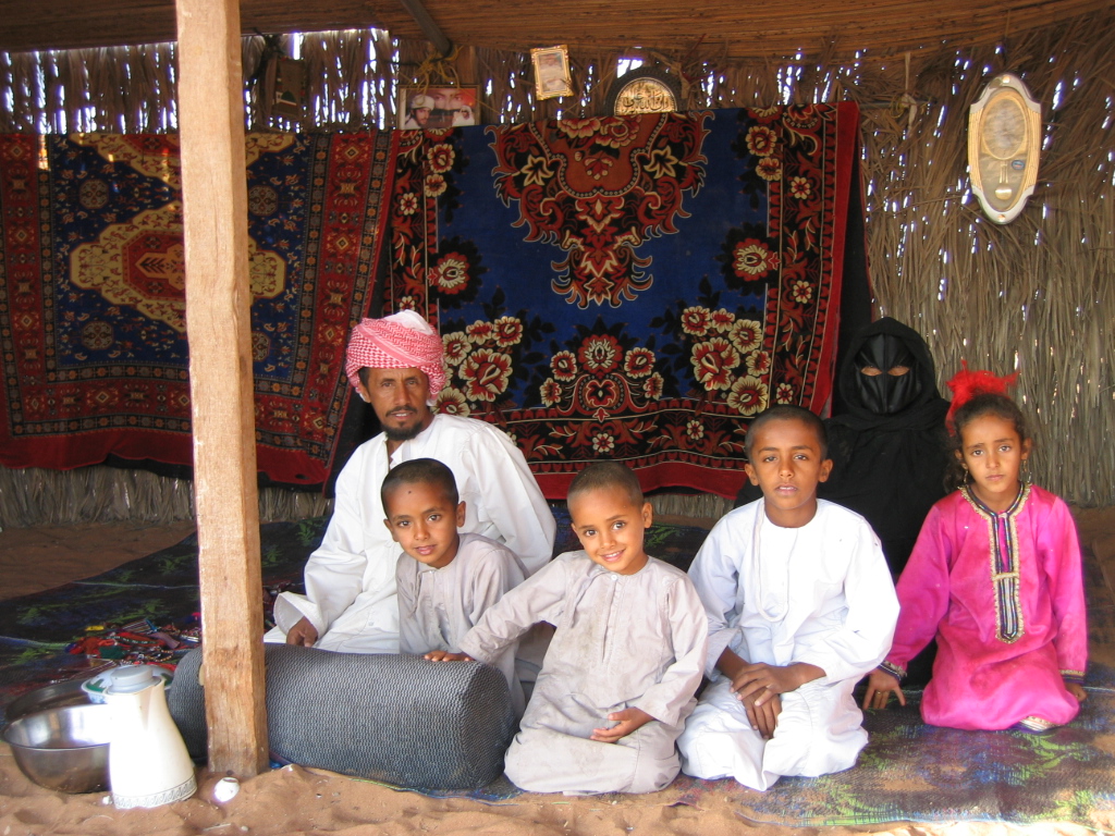 group of people sitting in front of carpeted area