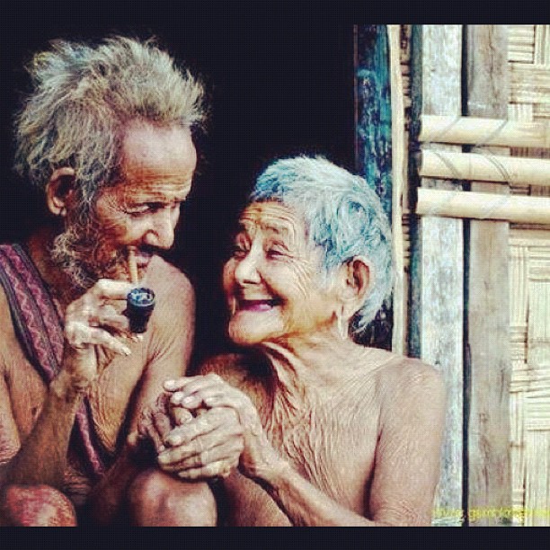 an old couple smiling with their hands together