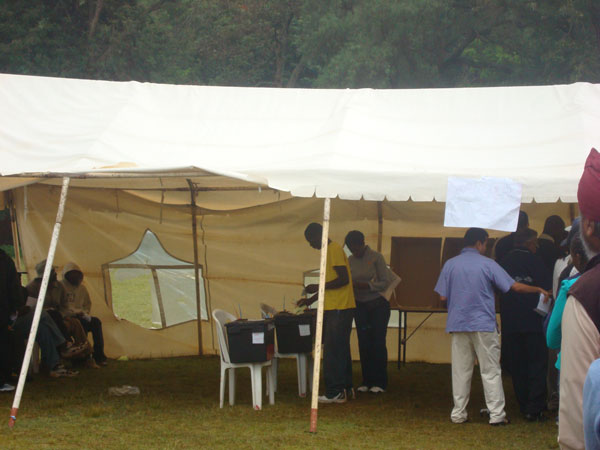 people standing in line at a tent set up