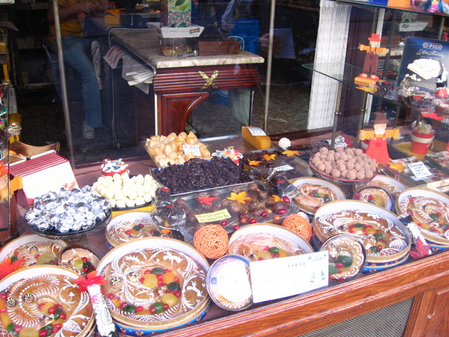 various cakes and desserts for sale on display
