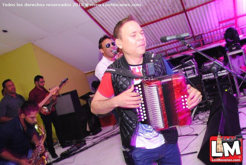 a man is holding an accordian in front of a crowd